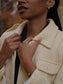 Cream herringbone jacket worn by a woman, featuring a collared neck and stylish accessories.