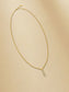 Elegant gold necklace with teardrop pendant adorned with sparkling crystals.