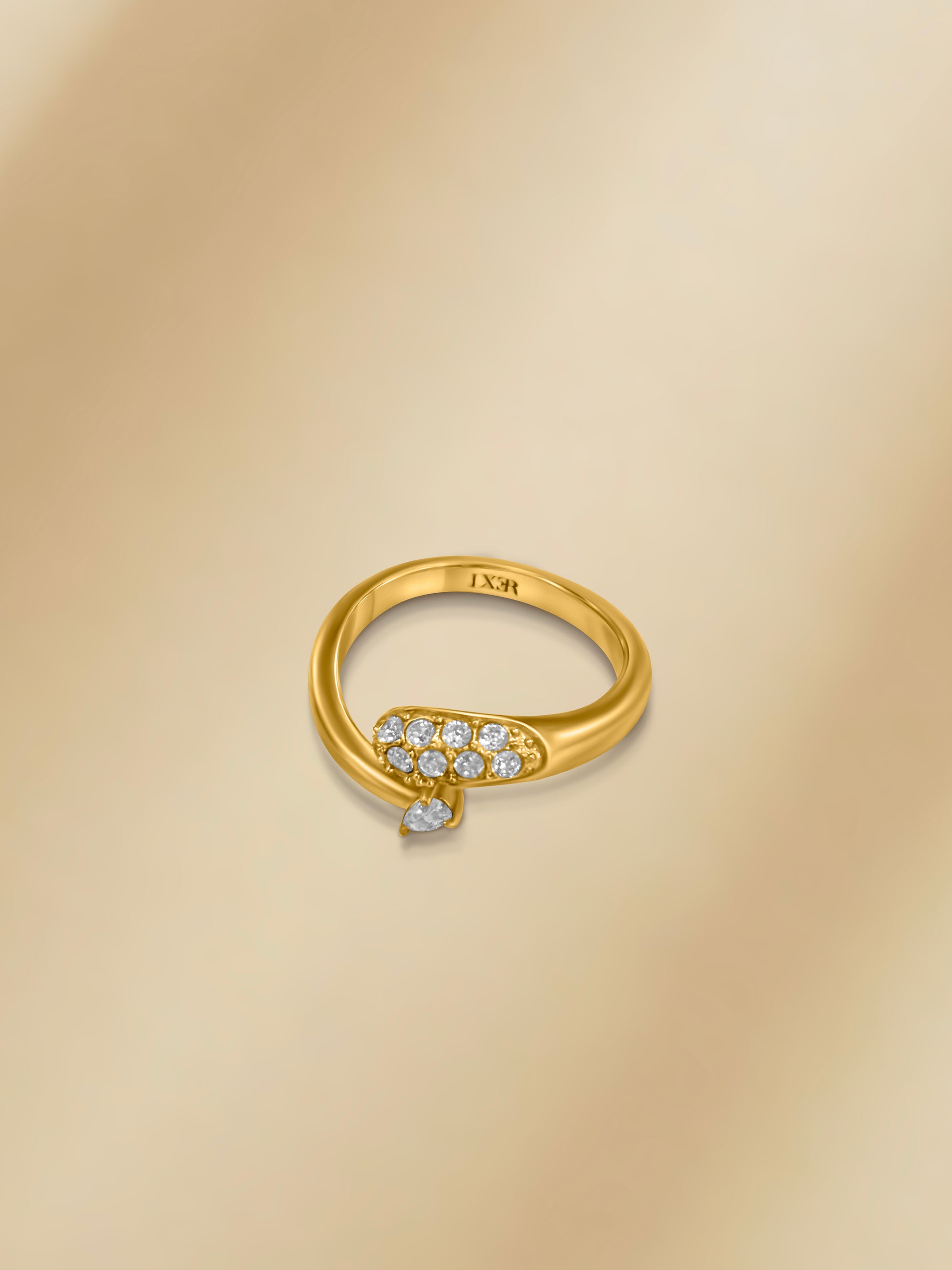 Gold snake ring with sparkling diamonds and a teardrop accent, elegant and unique design.